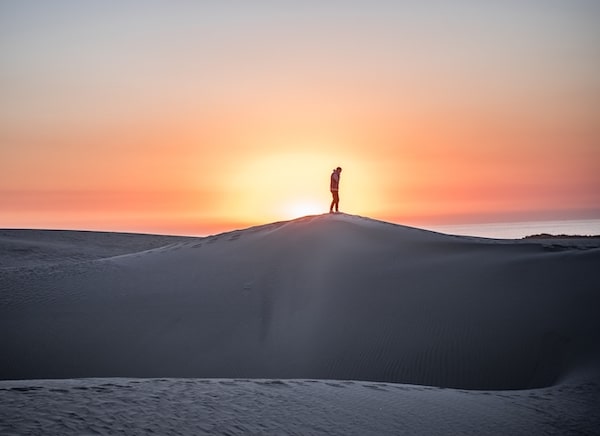 man in desert at sunrise
