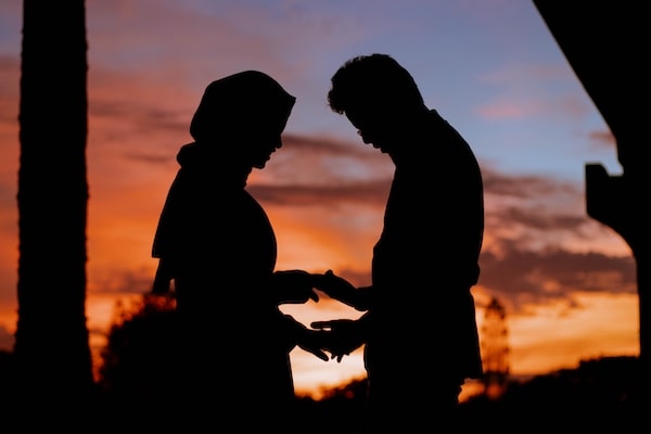 backlit couple at dawn